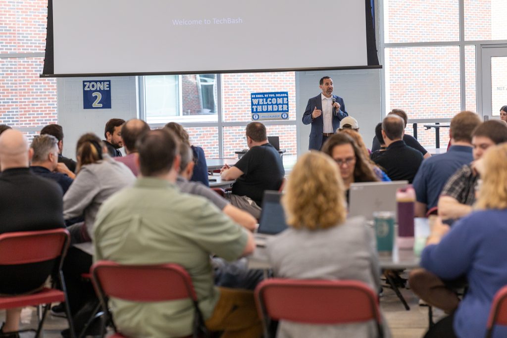 Superintendent presenting to large crowd during Kane County Tech Bash