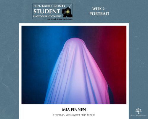 Person covered entirely by a white sheet standing against a blue and red gradient background.