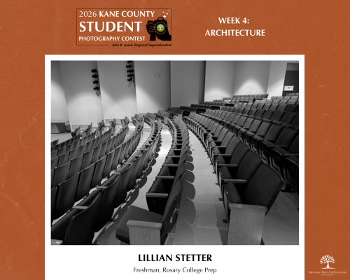 Black and white photo of an auditorium lined with many rows of seats